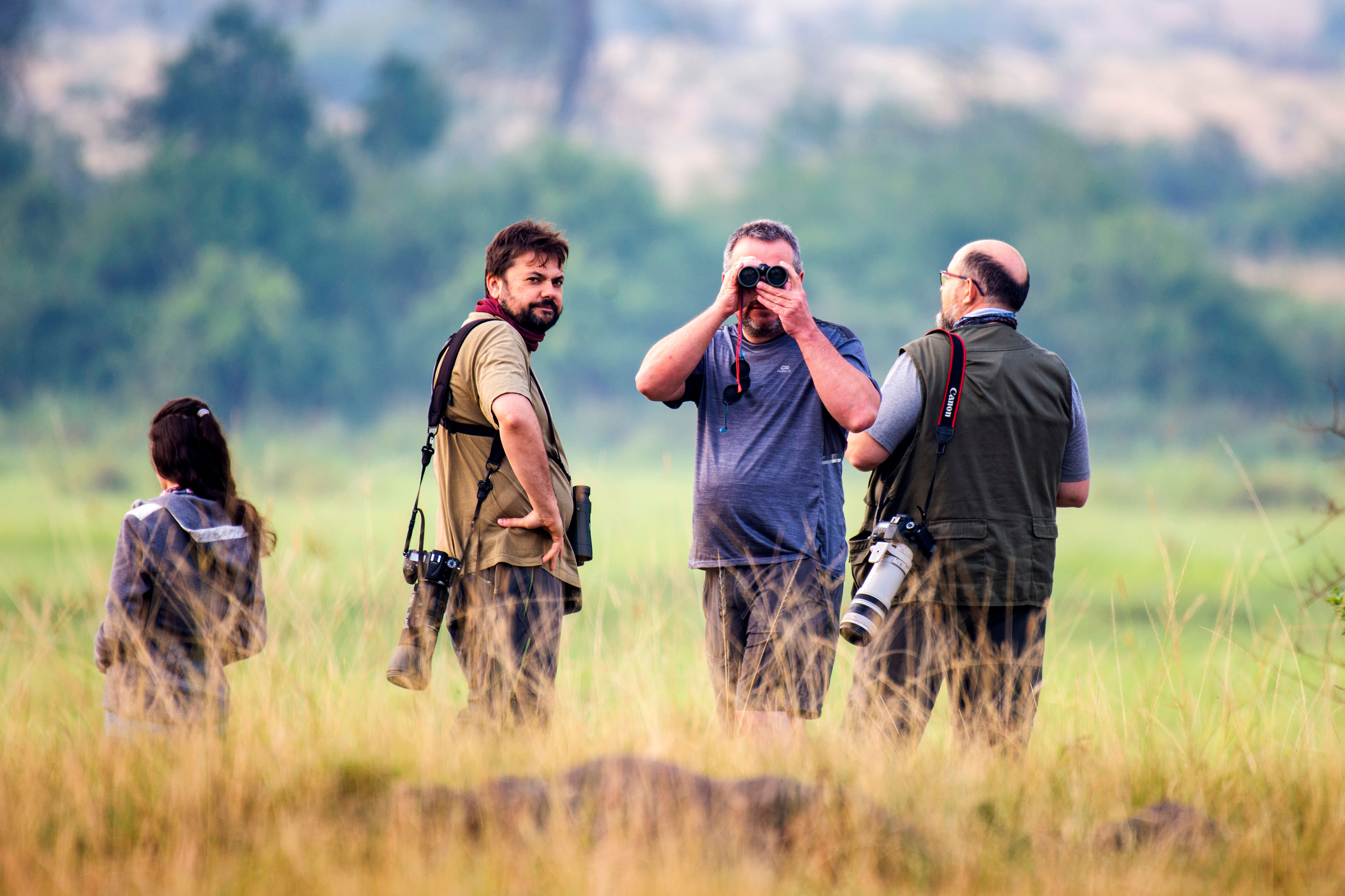 Expert guides leading tourists on safari in Queen Elizabeth National Park